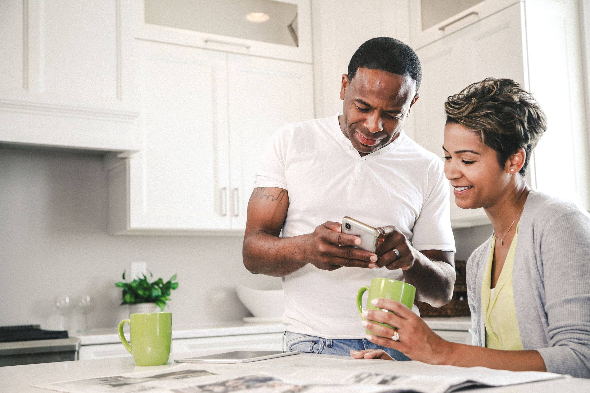 African American couple sitting in their kitchen talking.