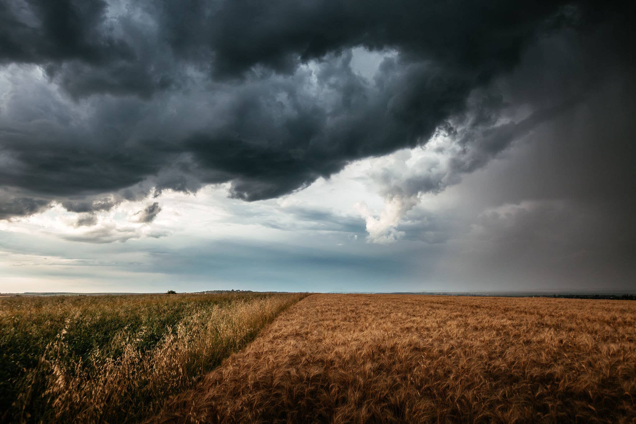 Dangerous storm clouds loom over the fields, creating an ominous atmosphere. Textured and dynamic sky. Epic clouds before a hurricane, weather conditions. Photo wallpaper. Discovery beauty of earth.; Shutterstock ID 2670194281; purchase_order: ; job: ; client: ; other: 