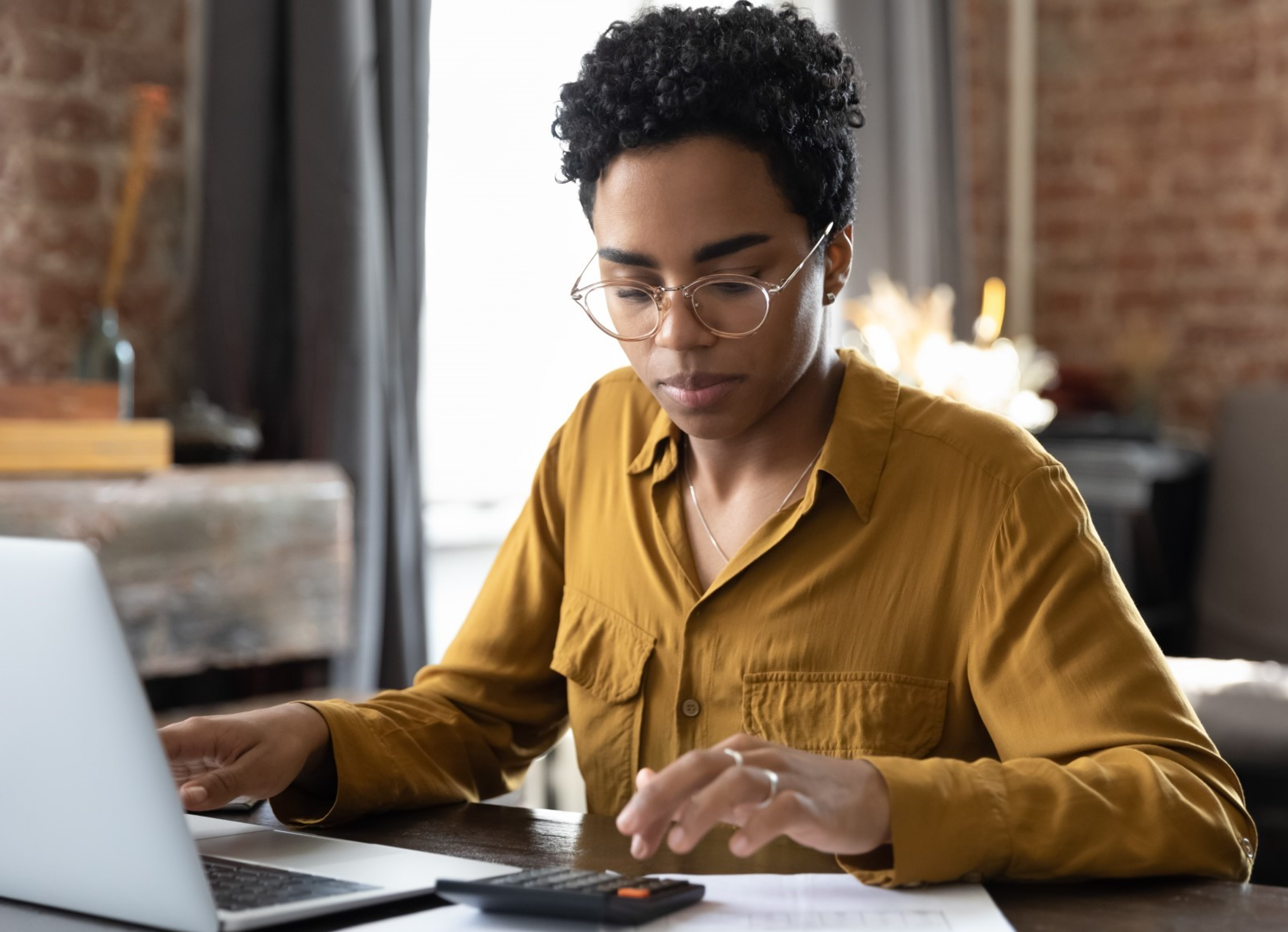 Woman in front of laptop doing financial planning