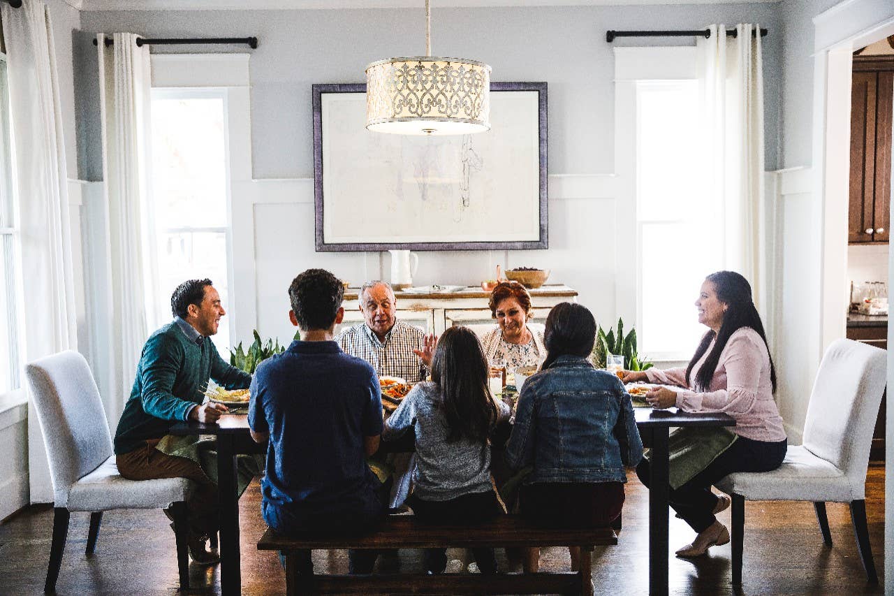 Family and friends sitting around a table.