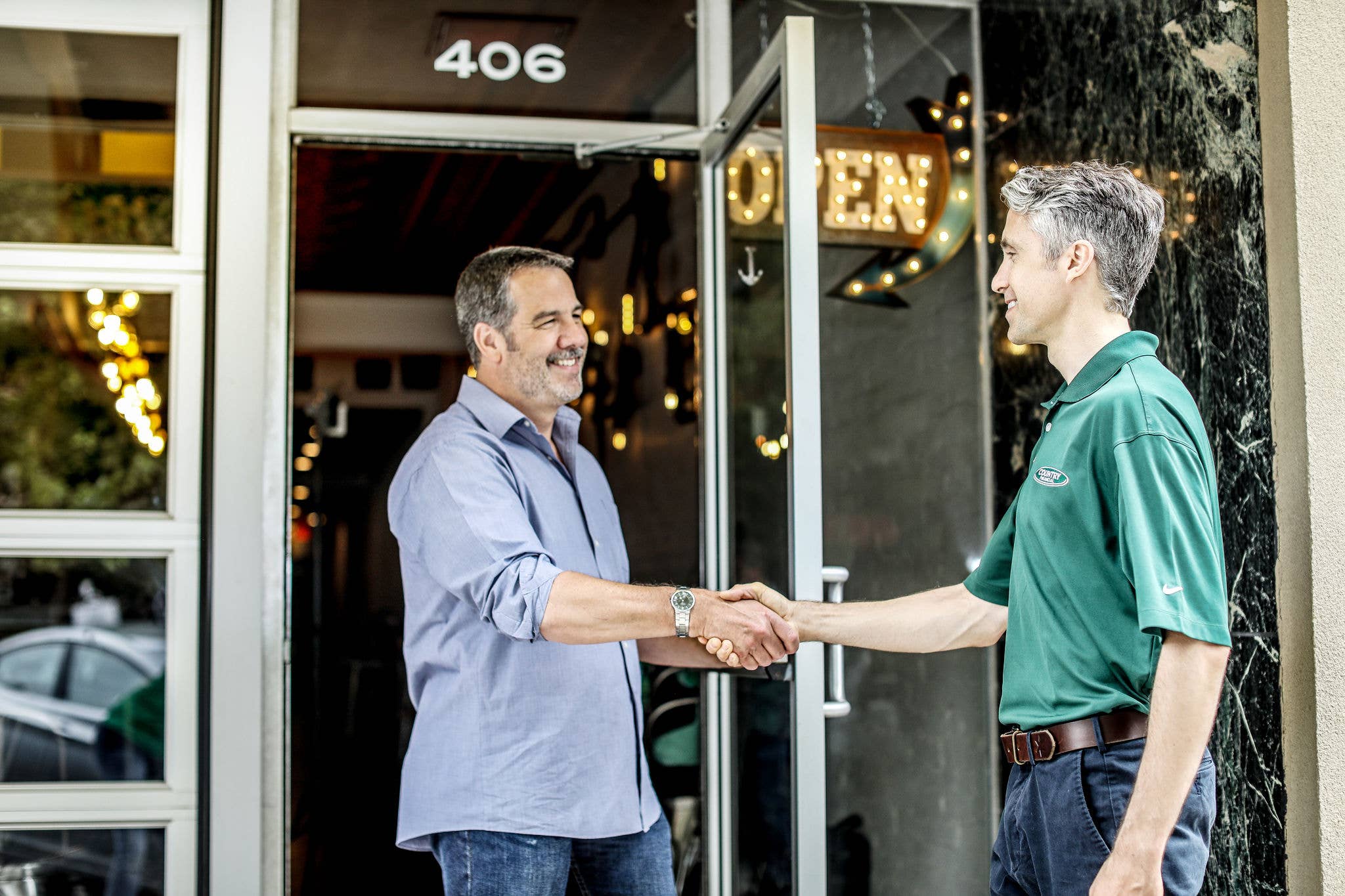 A COUNTRY Financial representative shaking hands with business owner.