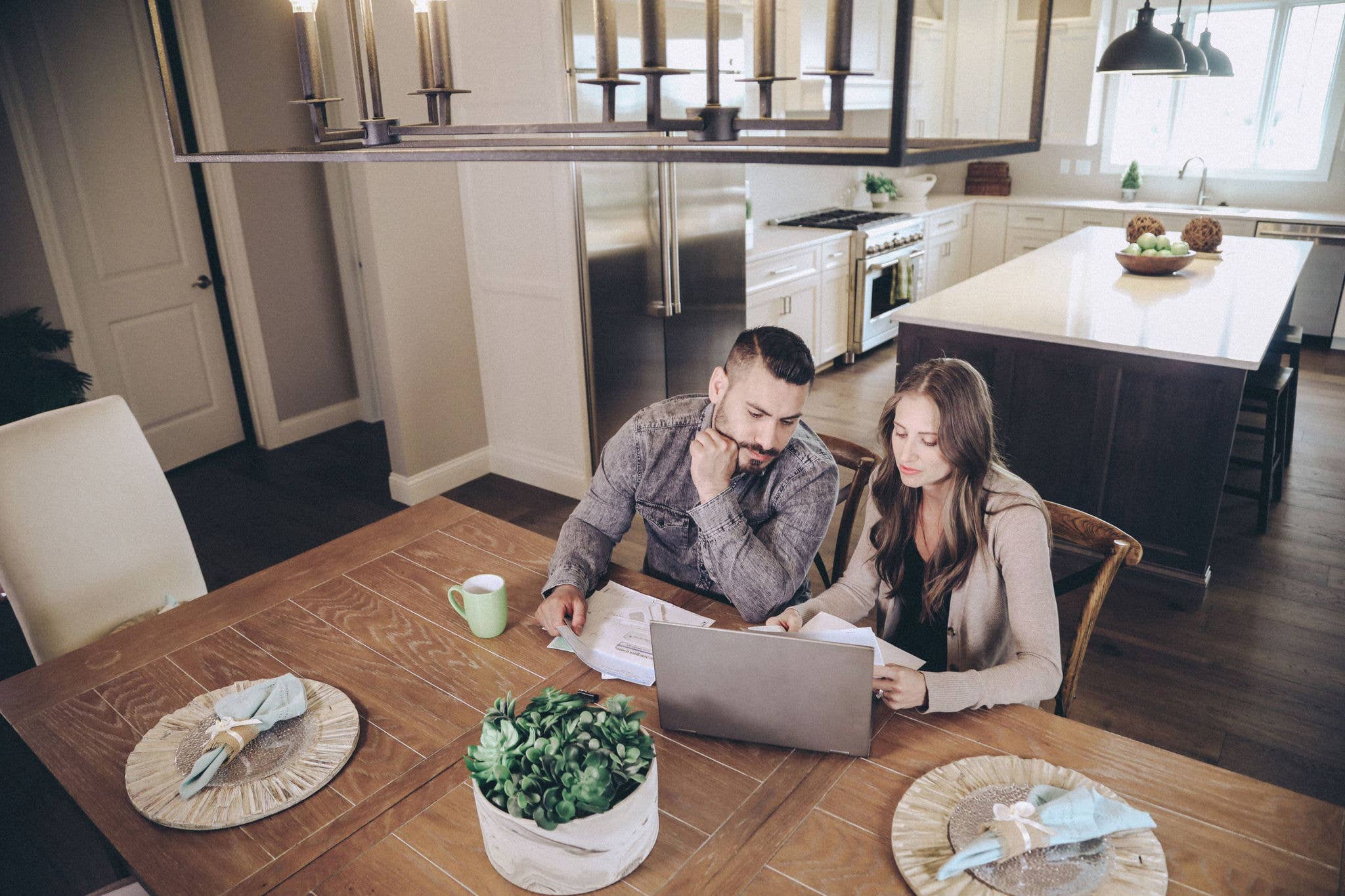 Couple sitting at dining table doing finances