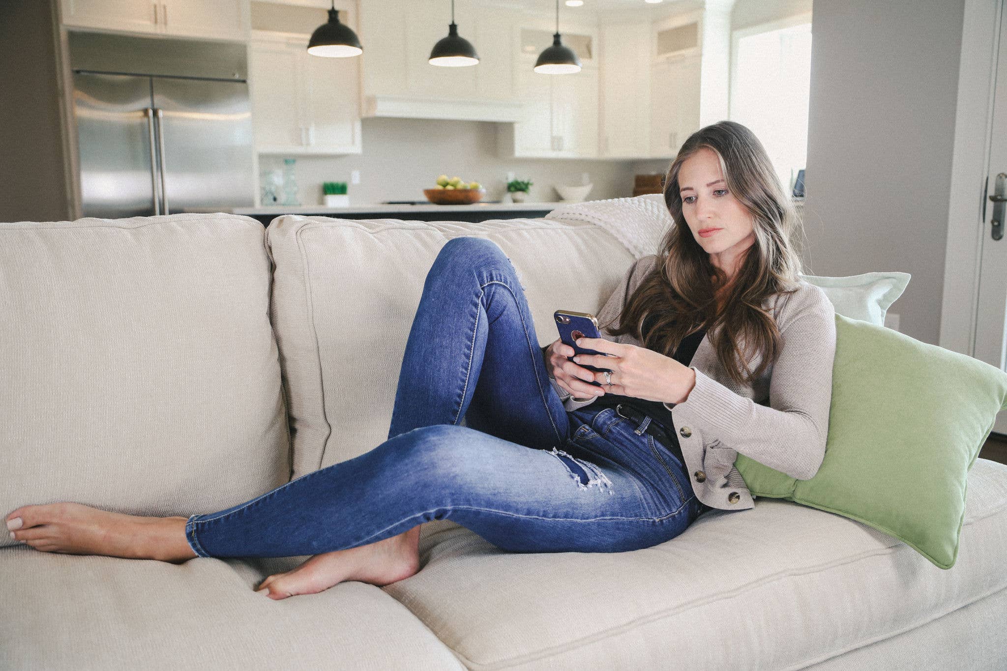 Woman on couch browsing on phone