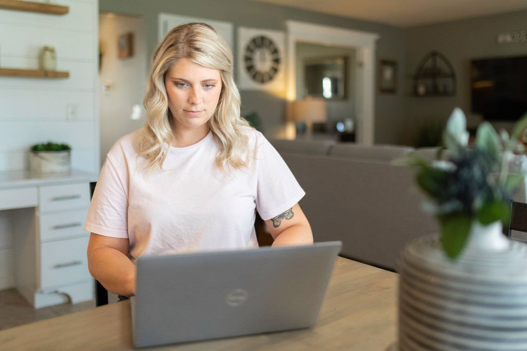 Woman on computer in kitchen