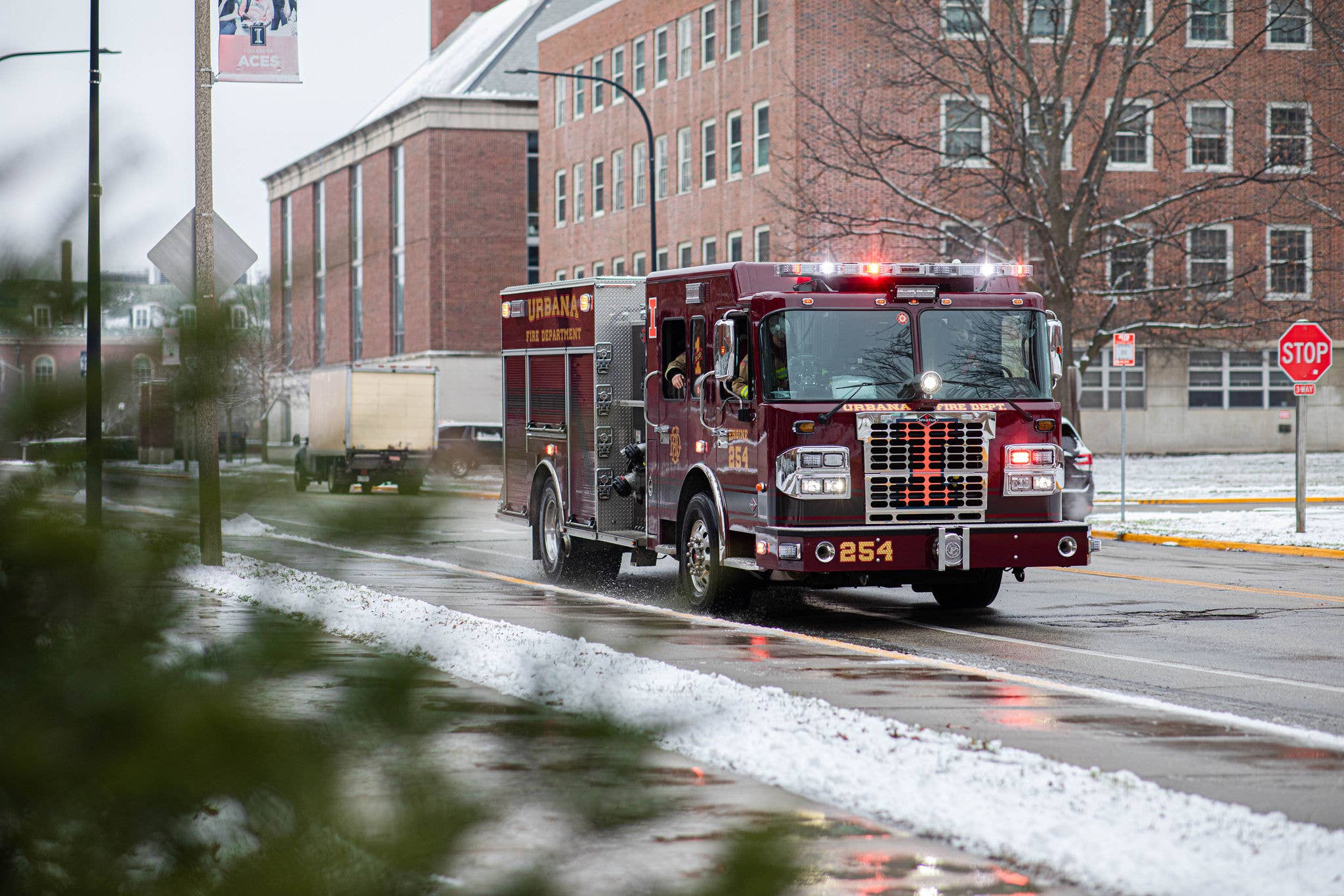 Fire truck driving down the road with its lights flashing.
