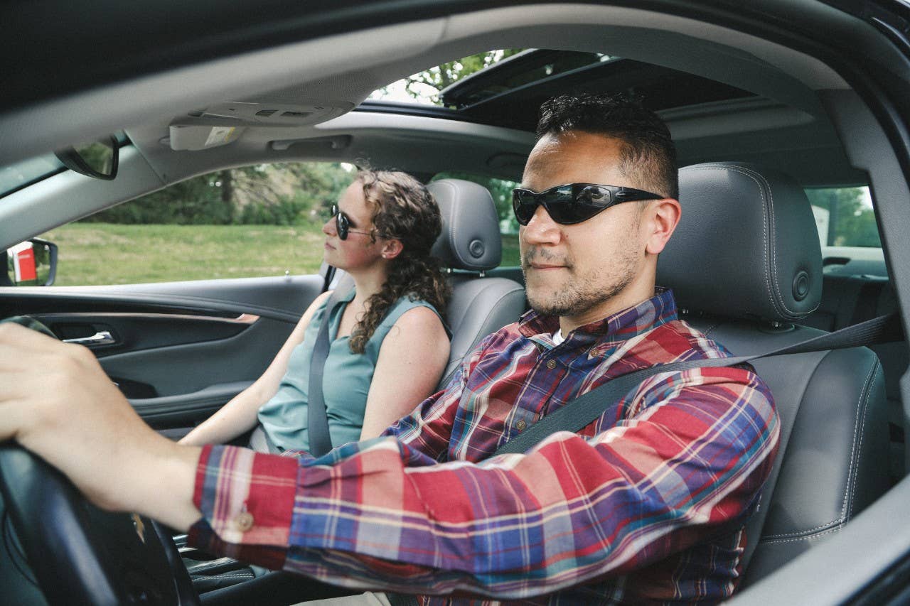 Male driving car with female passenger