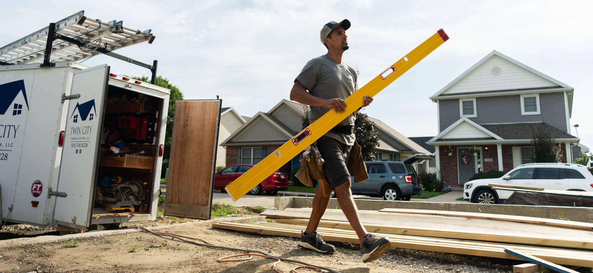 Man walking with yellow level on construction site