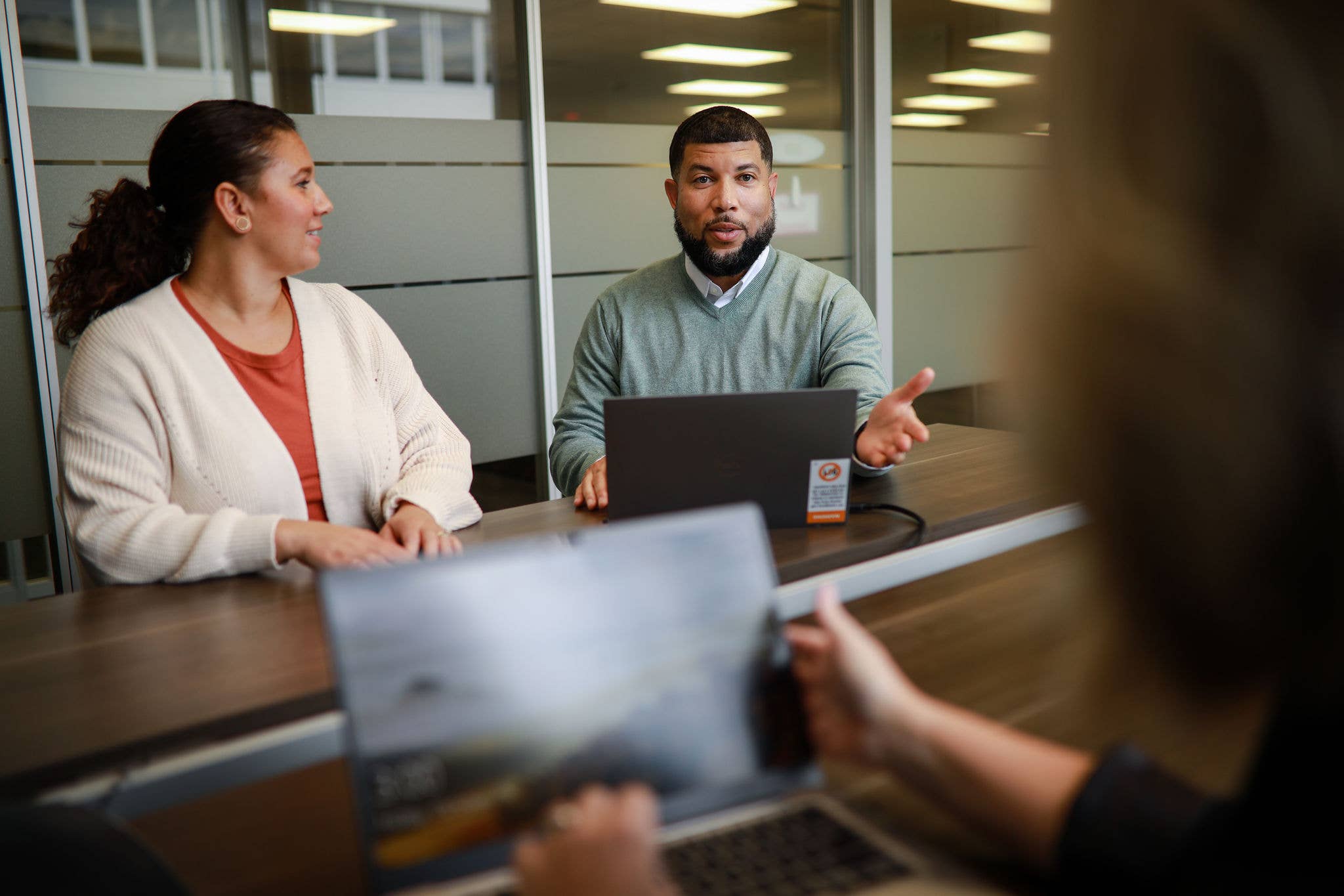 Three coworkers having a conversation