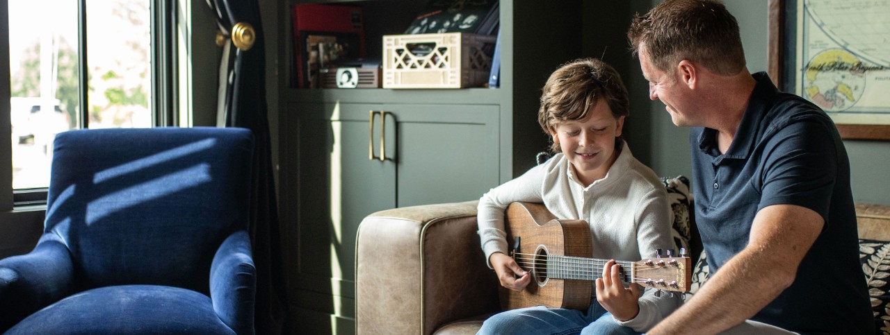Father and son playing guitar