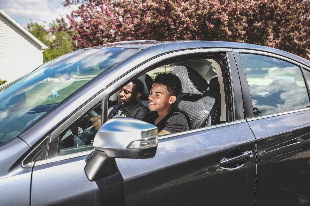 Father and son in black car