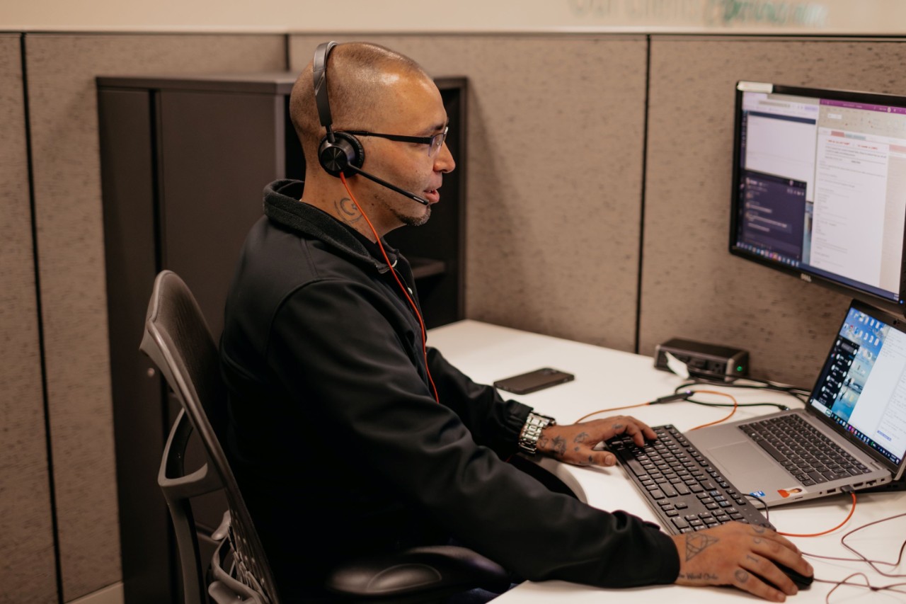 Claims rep at desk on phone