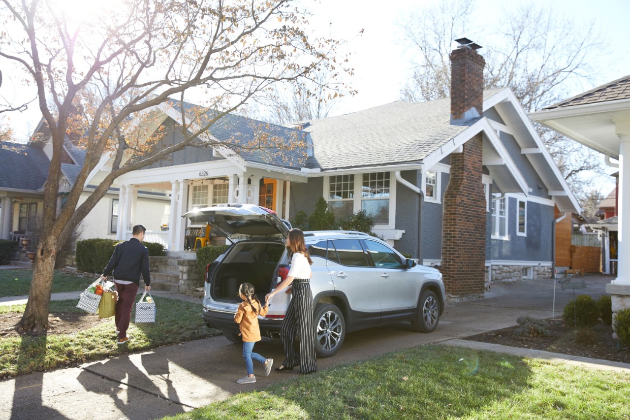 Family walking in house from car