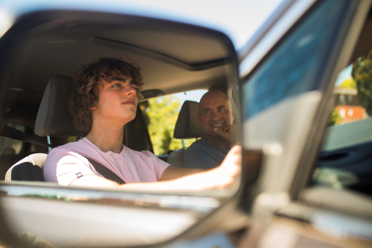 Kid learning to drive with parent