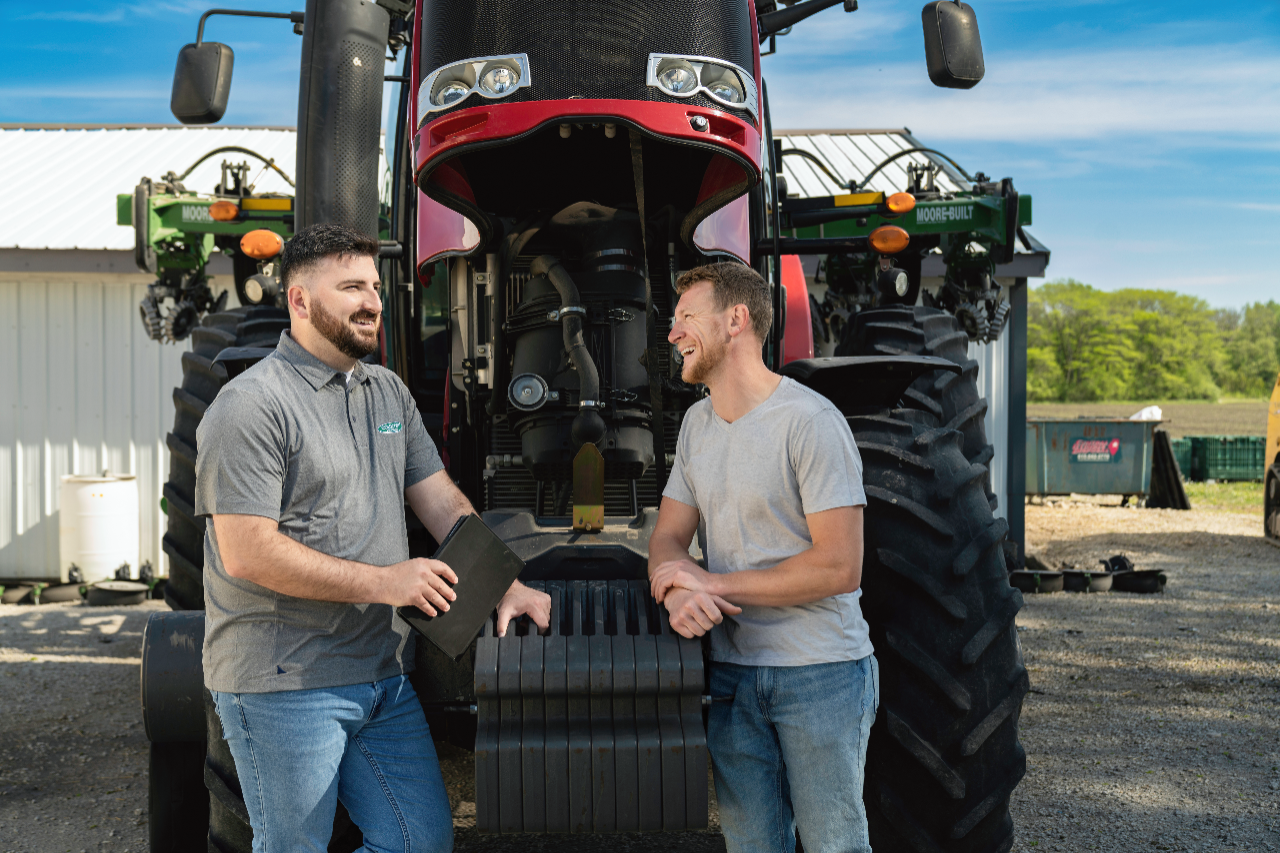 COUNTRY Financial rep meeting with farmer in front of tractor