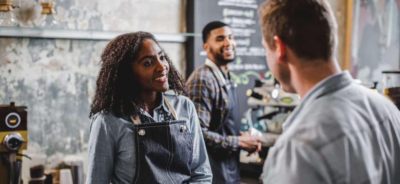 Barista helping customer purchase coffee