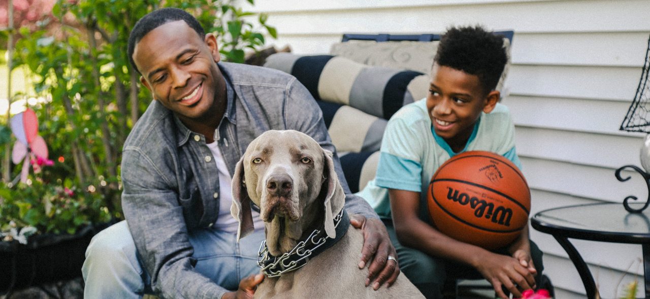 father and son with dog