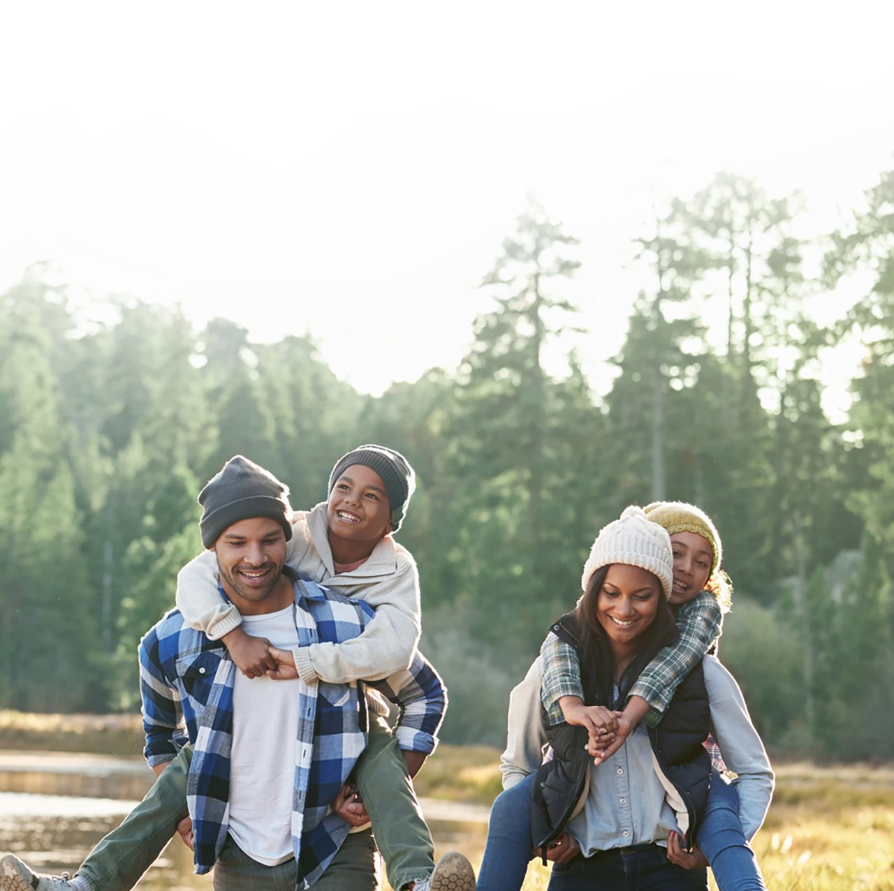 Happy family hiking by a river