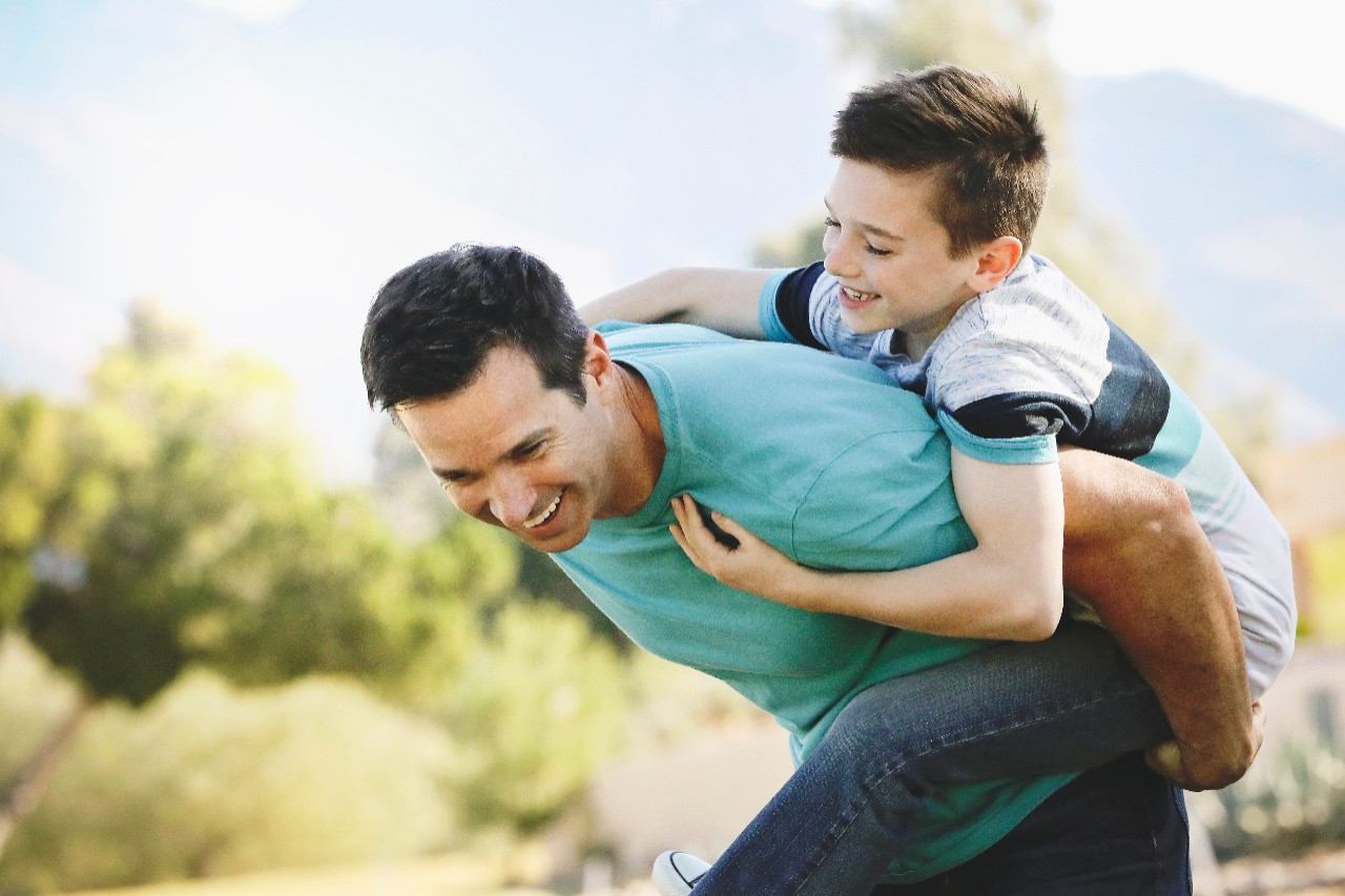 Father carrying son on his shoulders