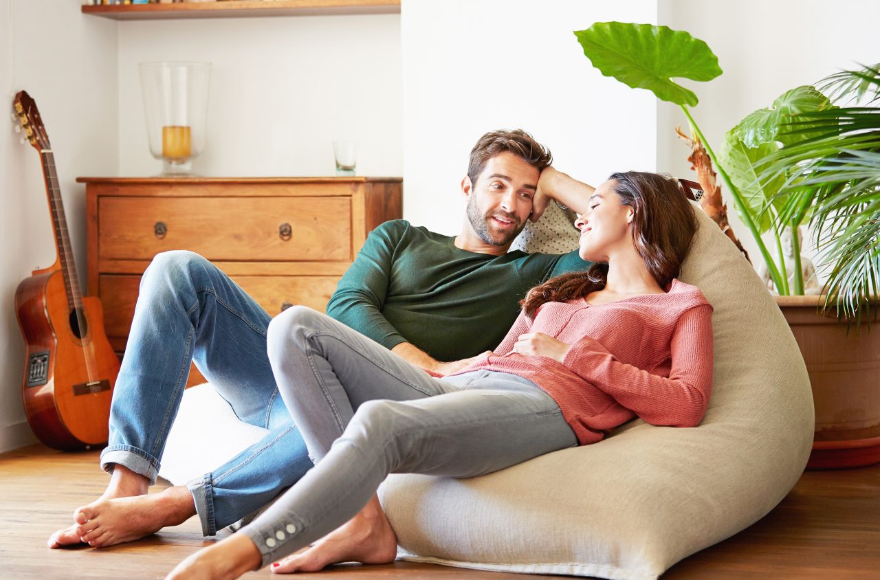 Woman sitting on couch on laptop