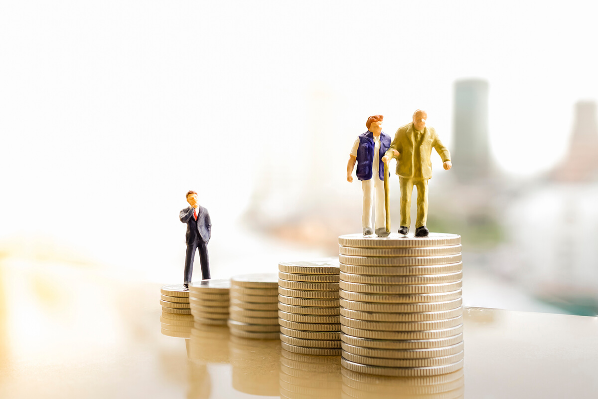 Plastic people figures standing on coins