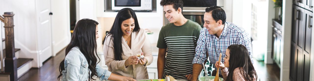 Family making meal at kitchen counter