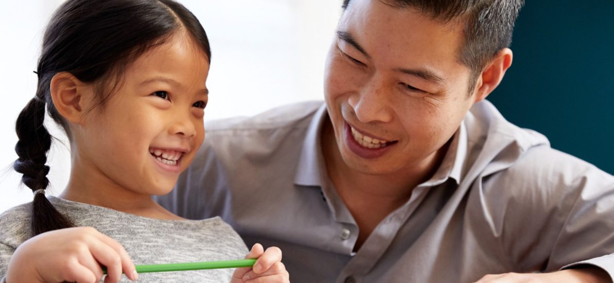 father doing schoolwork with daughter