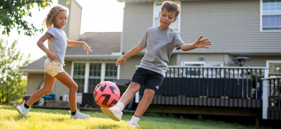 kids playing soccer in backyard