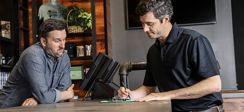 Worker talking to insurance agent at counter