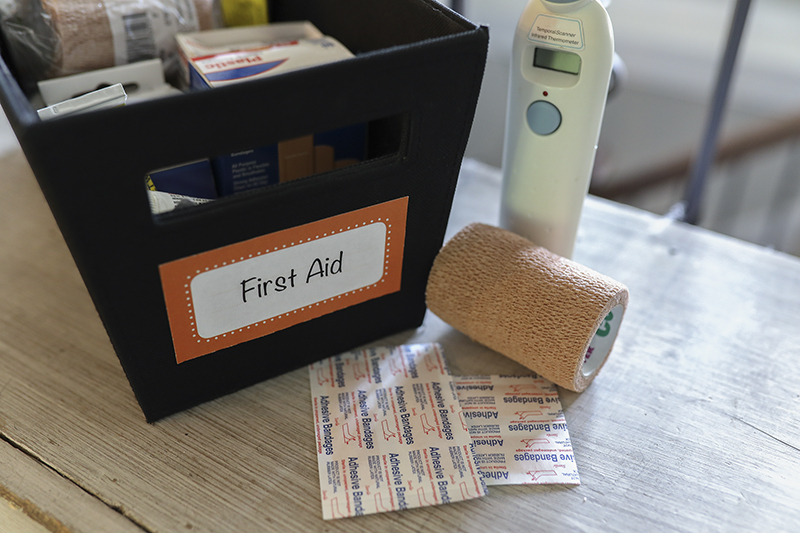 First aid kit on wooden counter