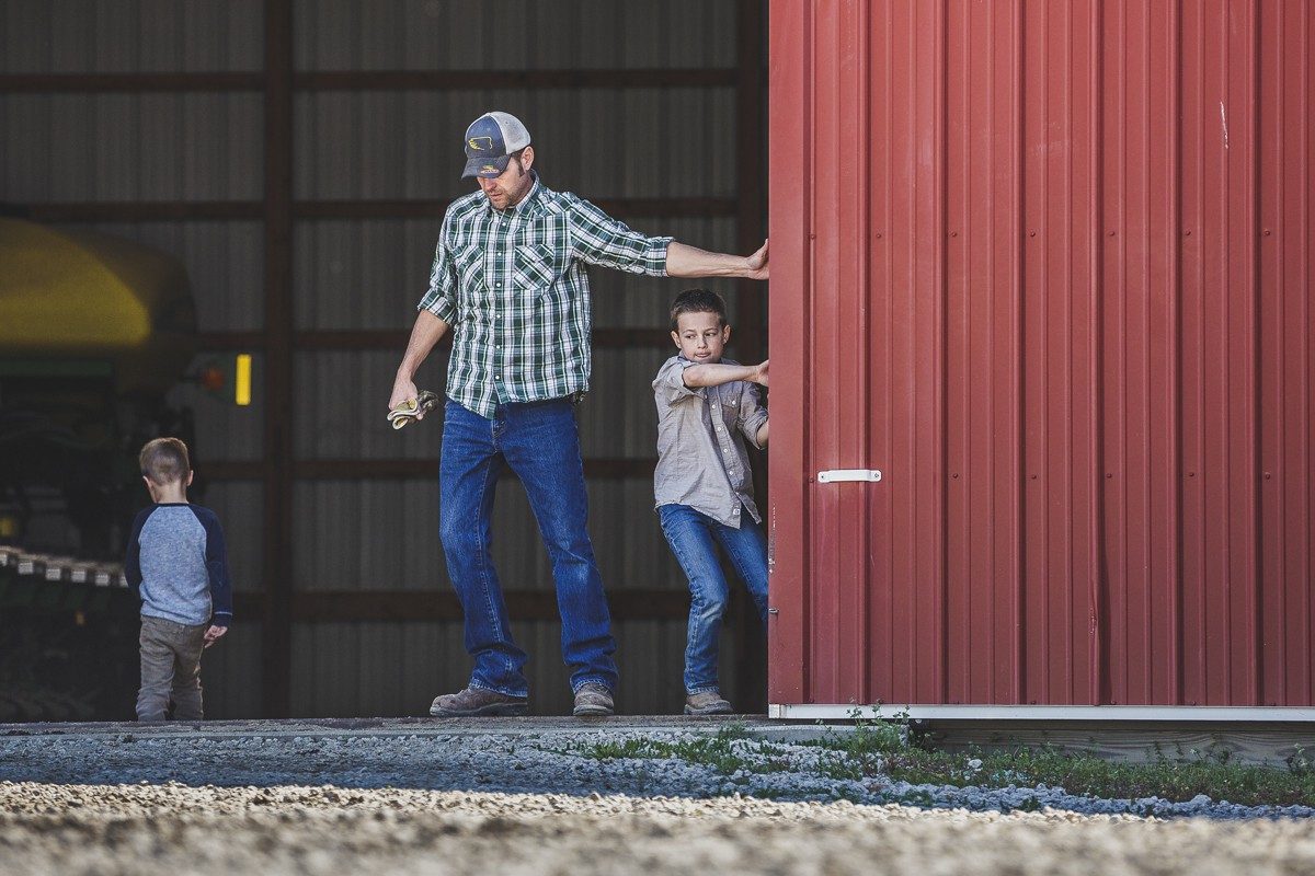 Father and son closing barn door