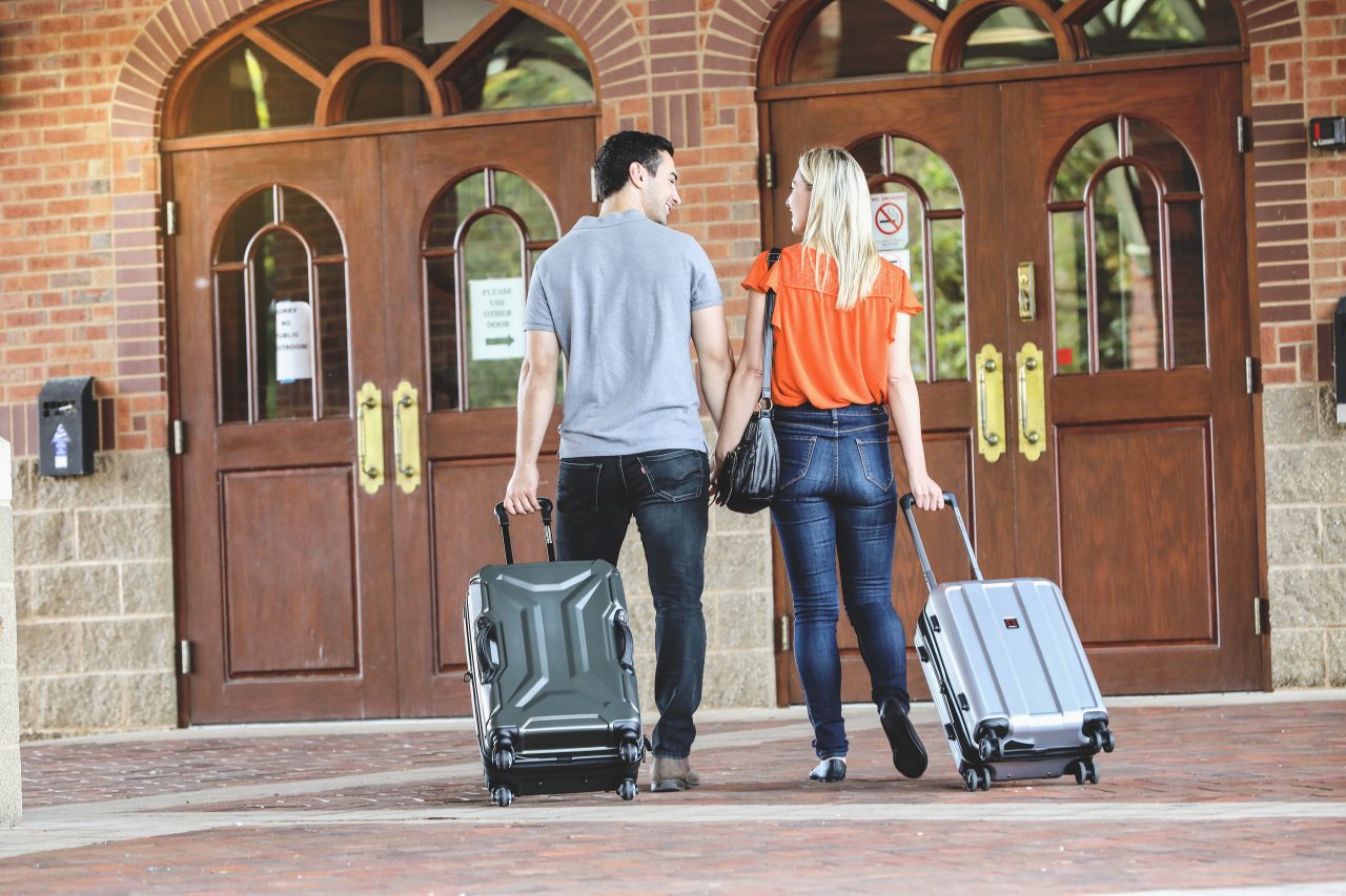 Couple rolling suitcases