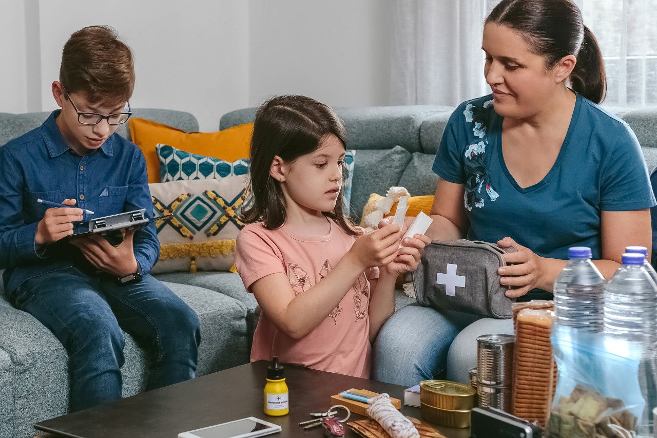 Mom and kids putting an emergency kit together
