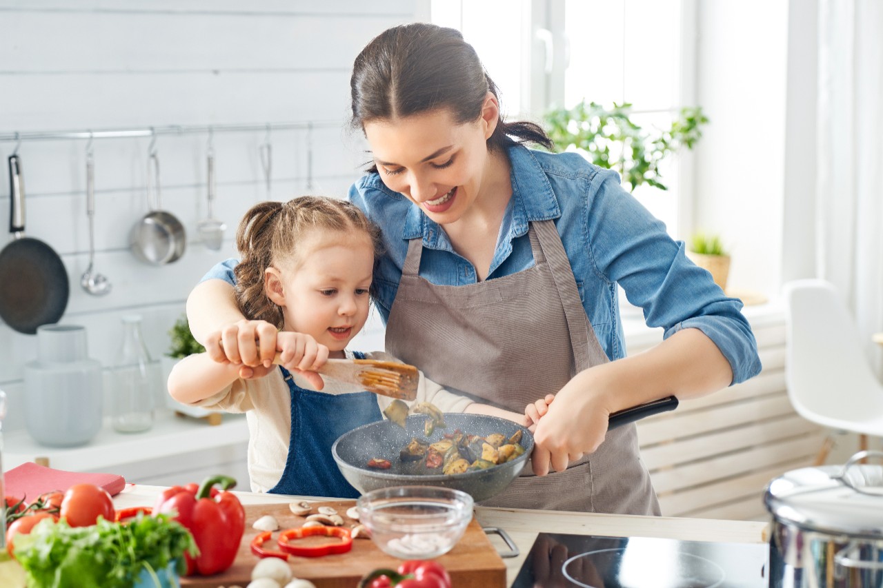 Mother and daughter cooking in the kitchen