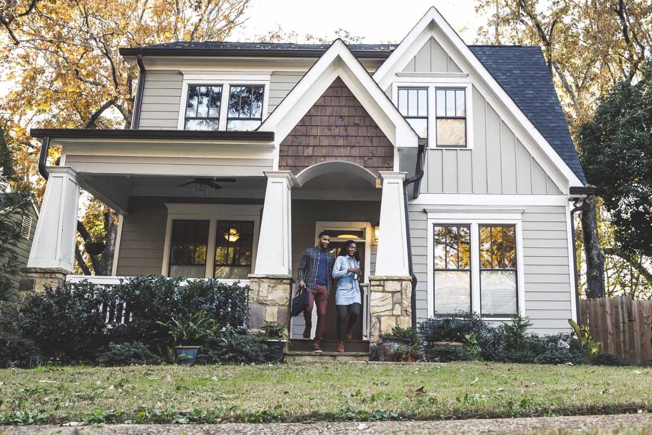 couple in front of house on street