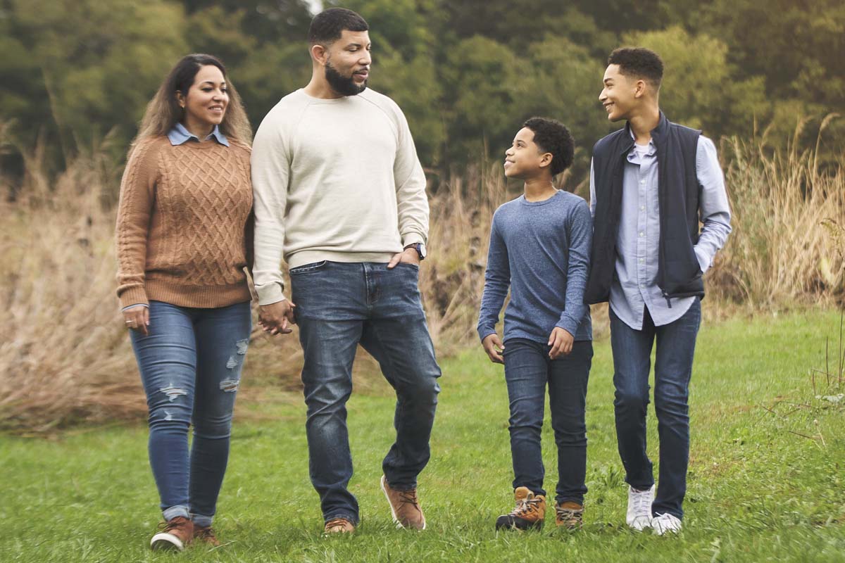 Family holding hands on a walk on path