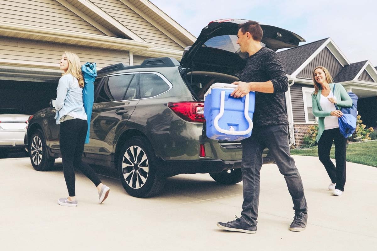 Family walking to red truck in driveway