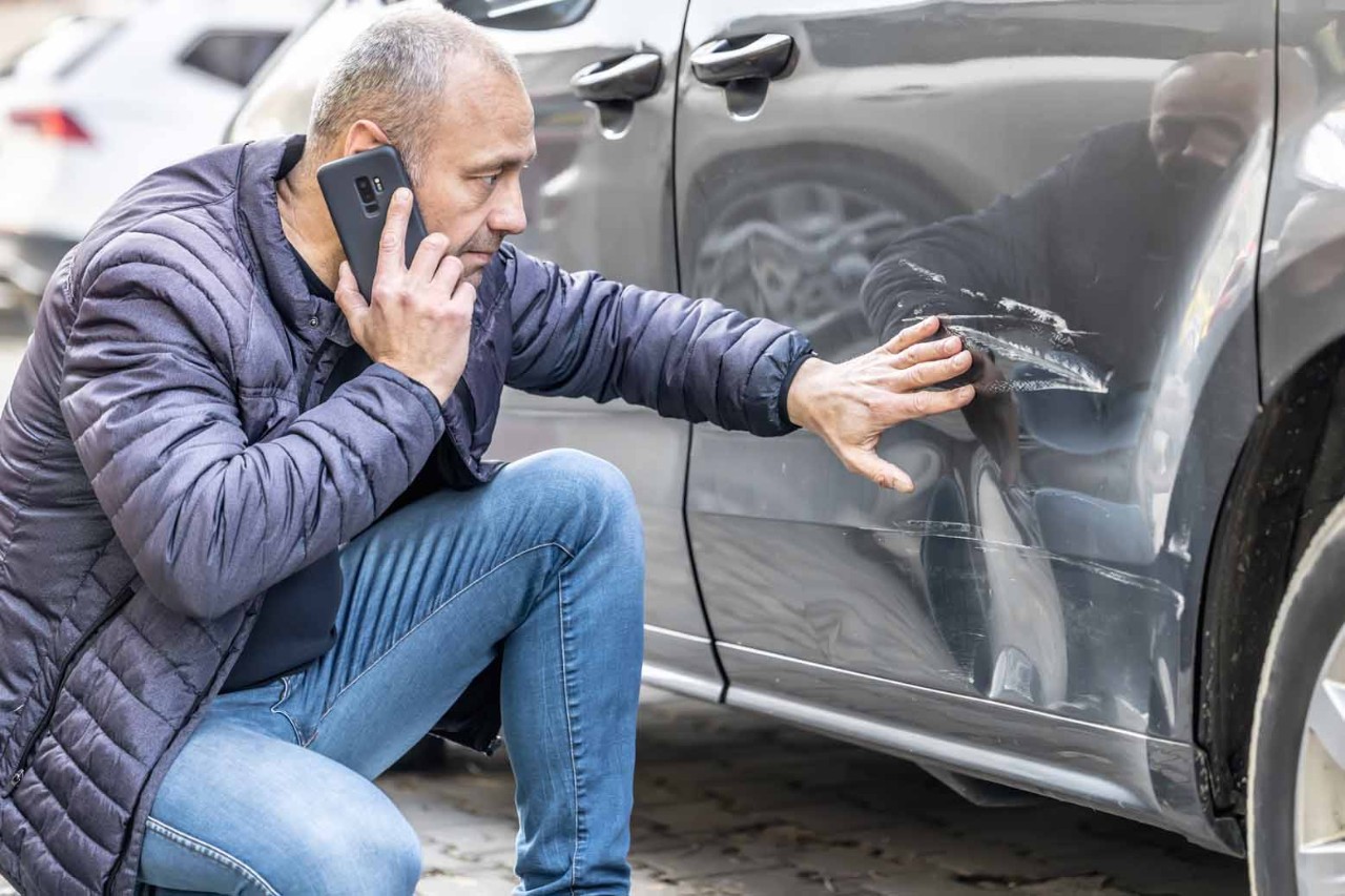 Man assessing car damage